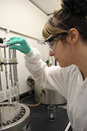 Krystle Stehno, a mathematics instructor from Williamsburg Community Schools, prepares a sample for testing in the Environment Health Section.