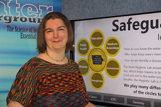 University of Iowa employee and graduate student Robyn Miessler-Kubanek stands by the interactive display she created for the UI Mobile Museum.